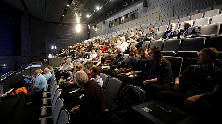 Attendees watching the opening plenary in the cinema
